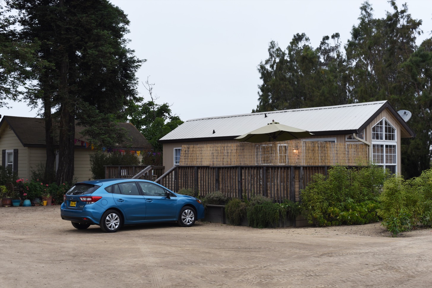 My Subaru Impreza parked outside a cabin.